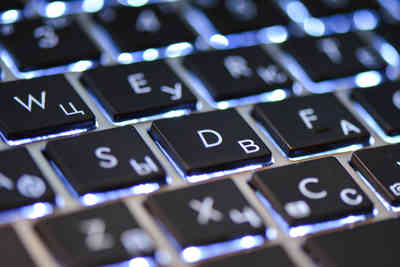 Hero picture: Apple Macbook Pro keyboard with backlight on.